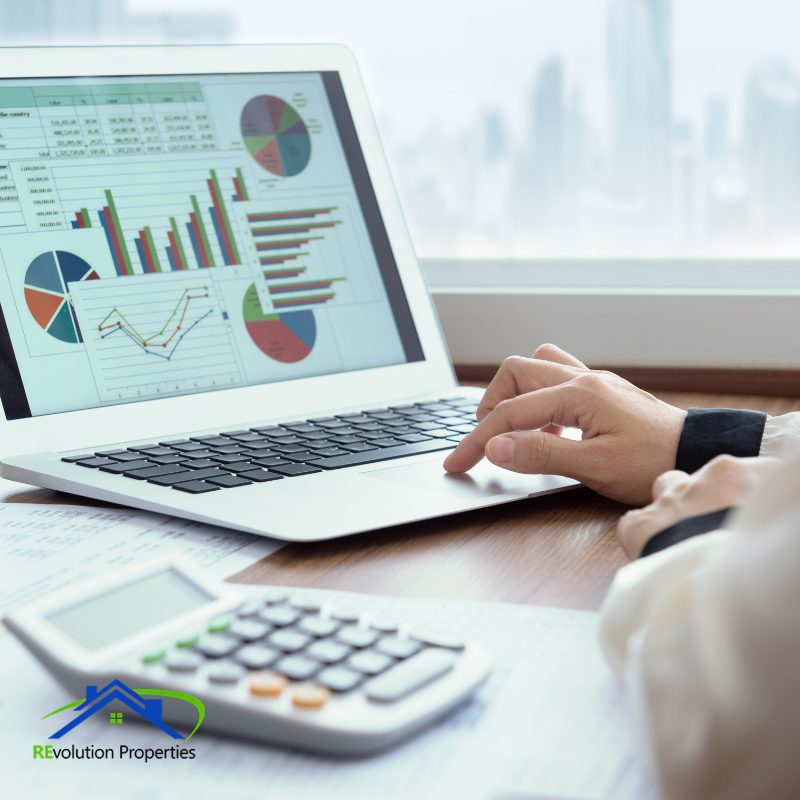 Property manager reviewing rental income and expense reports on laptop